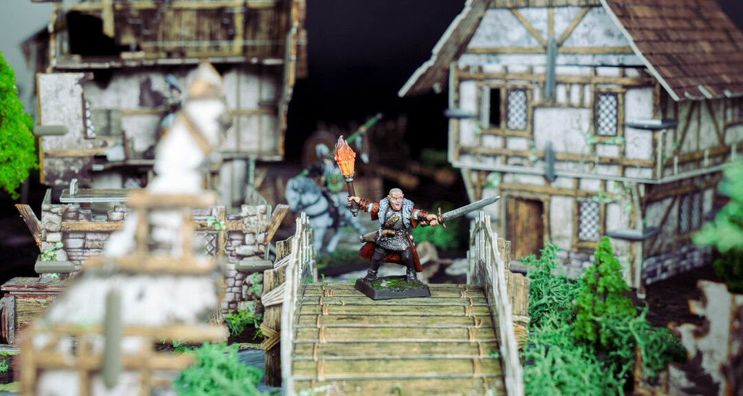 A witch hunter defends a bridge in Mordehim created using Battle Systems terrain